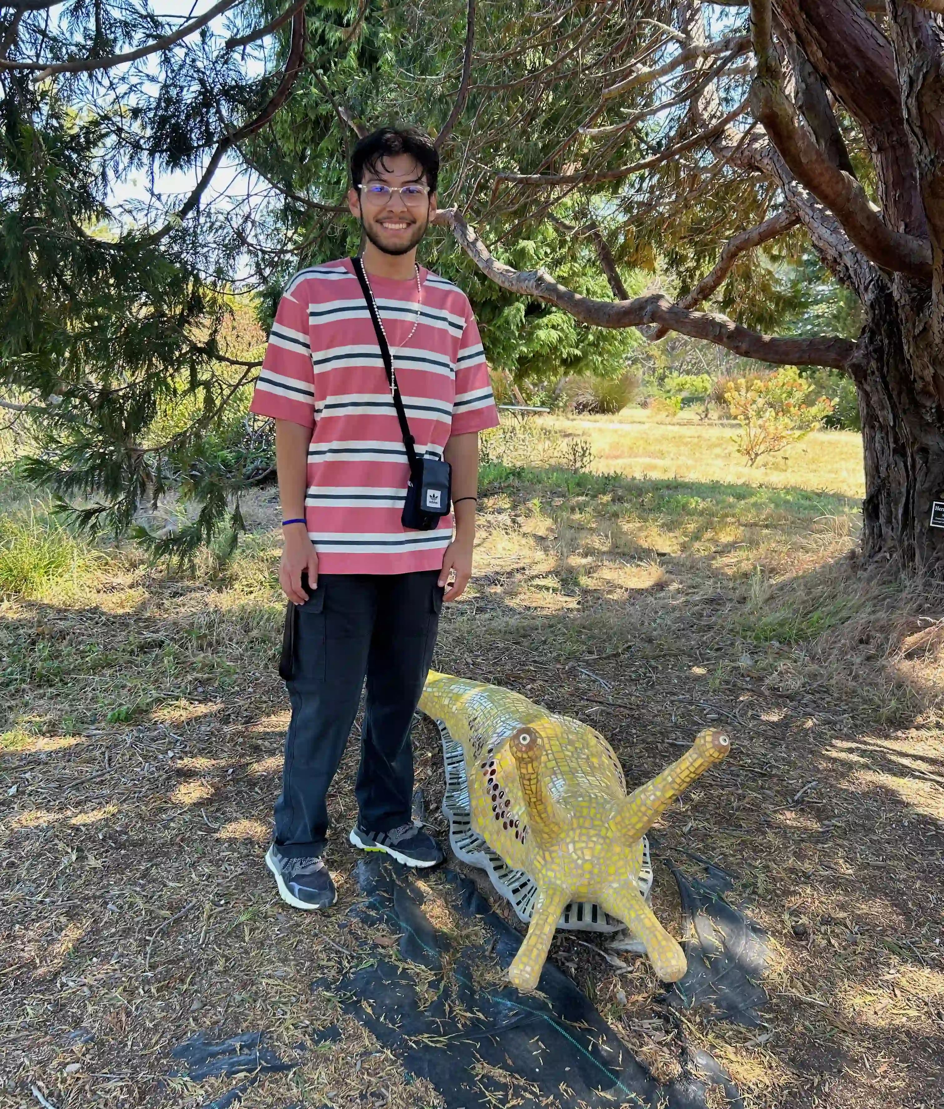 Eric posing with a banana slug statue at the UC Santa Cruz Arboretum